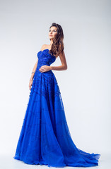 Young woman in a beautiful blue evening dress