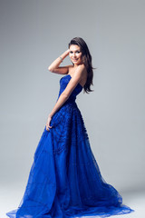 Young woman in a beautiful blue evening dress