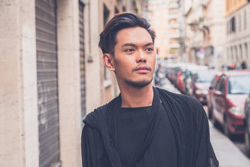 Handsome Asian model posing in the city streets