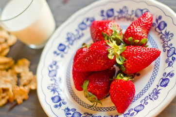 Biscuits, cornflakes, strawberry and milk