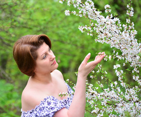 adult woman near the cherry blossoms