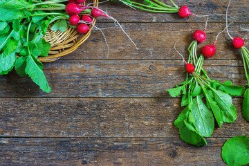 Fresh radishes on old wooden table