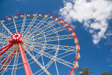 Atraktsion Ferris wheel against the blue sky © zheltobriukh