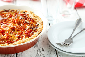 Fresh tomato pie on white wooden background