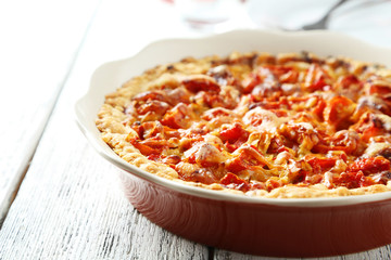 Fresh tomato pie on white wooden background