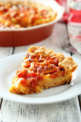 Fresh tomato pie on white wooden background