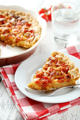 Fresh tomato pie on white wooden background