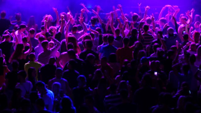 Crowd of young people dancing on party