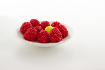 Blackberry jelly red, green, yellow and blue on a white saucer