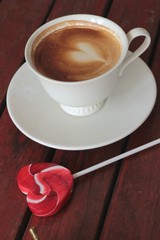 Hot latte coffee in glass and candy sweet valentines heart