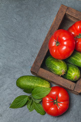 Cucumbers and Tomatoes in wooden box