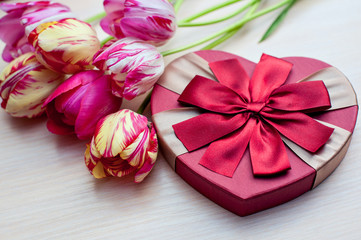 Tulips and boxes with gifts on a white background