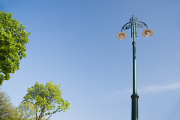 Mast lighting streets of the city on a background  the sky