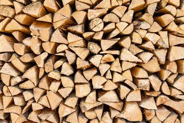 Background of chopped firewood stacked up on top of each other