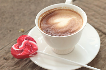 Hot latte coffee in glass and candy sweet valentines heart