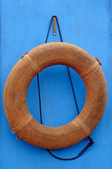 Lifebuoy on a background of blue wall of the boat