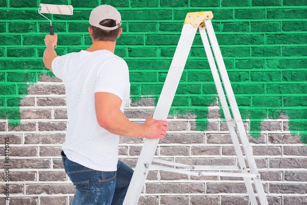 Poster handyman climbing ladder while using paint roller