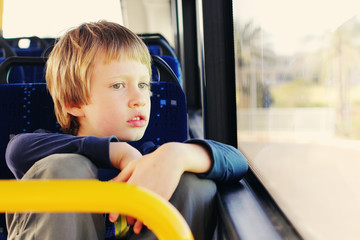 Cute autistic boy siting in empty bus - 83120919