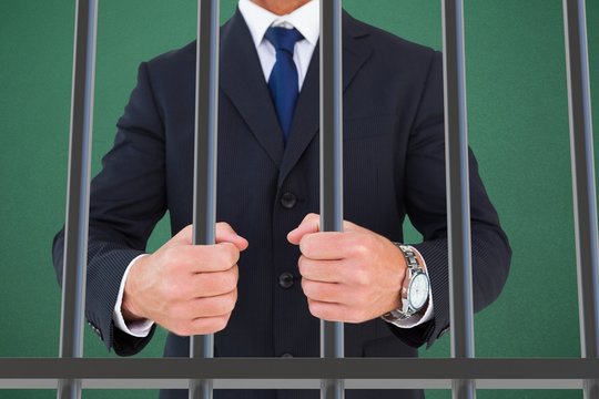 Composite image of portrait of a businessman clenching fists
