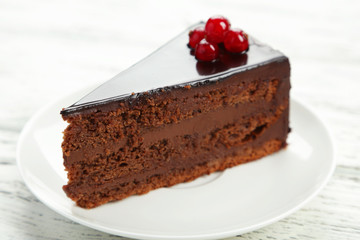 Dark chocolate cake on white wooden background