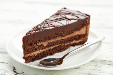 Dark chocolate cake on white wooden background