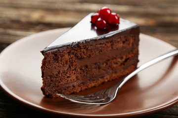 Dark chocolate cake on brown wooden background