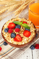 Oatmeal with berries on brown wooden background