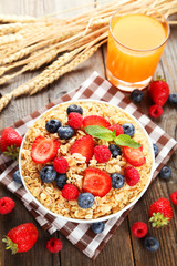 Oatmeal with berries on brown wooden background