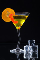 Martini drink served on glass table with ice cubes