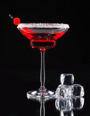 Martini drink served on glass table with ice cubes