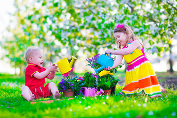 Kids in a garden with blooming cherry trees