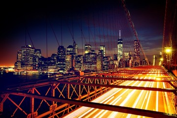 Brooklyn Bridge, Downtown Manhattan, New York. Night scene. Light trails. City lights. Urban living...