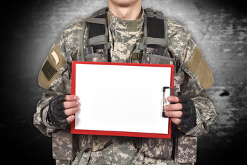 soldier holding blank clipboard