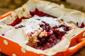 Orange ceramic dishes with berry pie