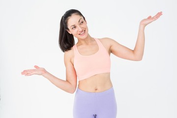 Fit brunette presenting with her hands