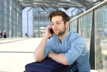 Man sitting on floor talking on mobile phone