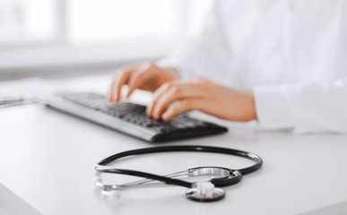 male doctor typing on the keyboard