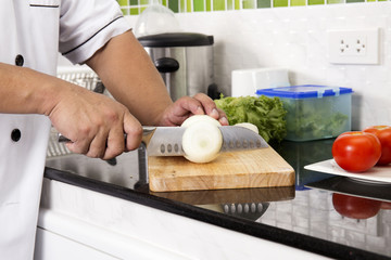 Chef cutting onion for making Hamburger