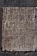 Closeup of rock monastery wall with armenian inscription