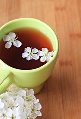 cup fresh herbal flower tea wooden table background