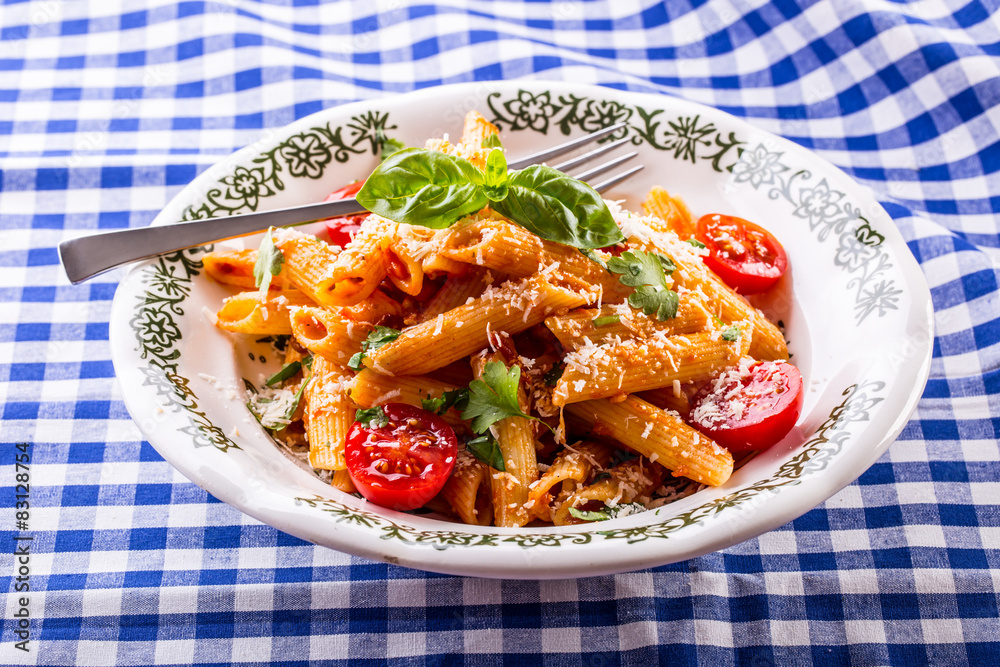 Wall mural plate with pasta pene cherry tomatoes basil leaves