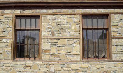 Stone cladding plates on the wall with windows