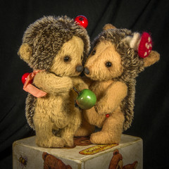 Puppets standing brown hedgehog with apple.