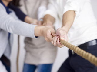 group of business people doing tug-of-war