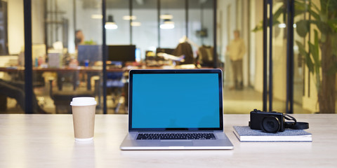 laptop with blue screen in office