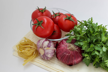 Vegetables for coocking pasta: garlic, onion, tomato, parley