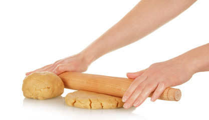 Women's hands roll out the dough