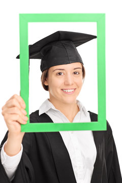 Female student posing behind a green picture frame