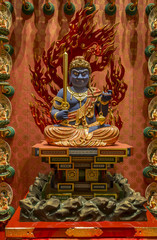 small statue of Buddha, in a Buddhist temple in Singapore