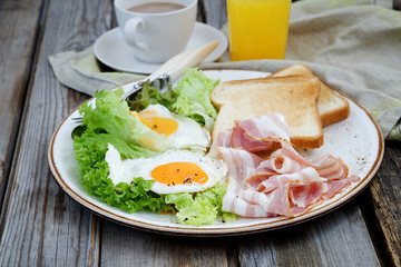 Breakfast on a plate: fried eggs, bacon and lettuce